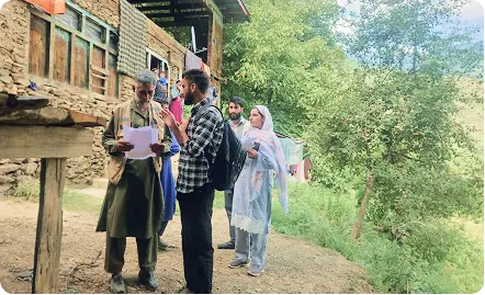 REACHA field team meeting residents in a Kashmir valley village